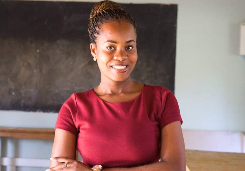 Woman Standing In Front Of Blackboard