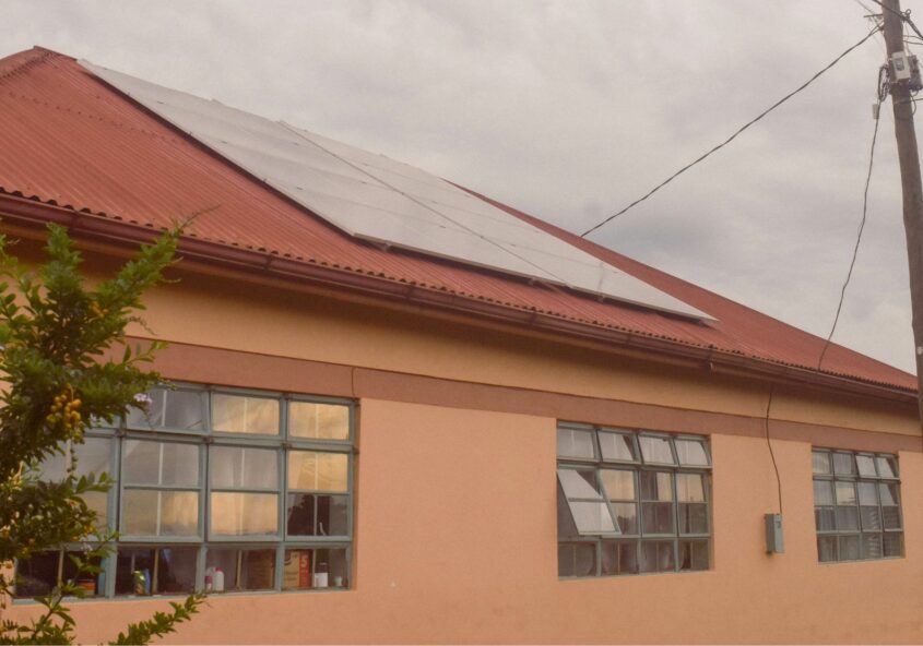 Groundbreaker Talents campus building in Uganda with rooftop solar panels powering tech education