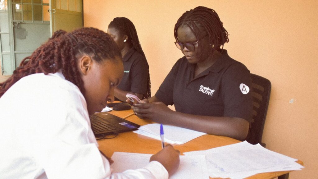 Young woman completing her application during Groundbreaker Talents Application Day in Uganda.